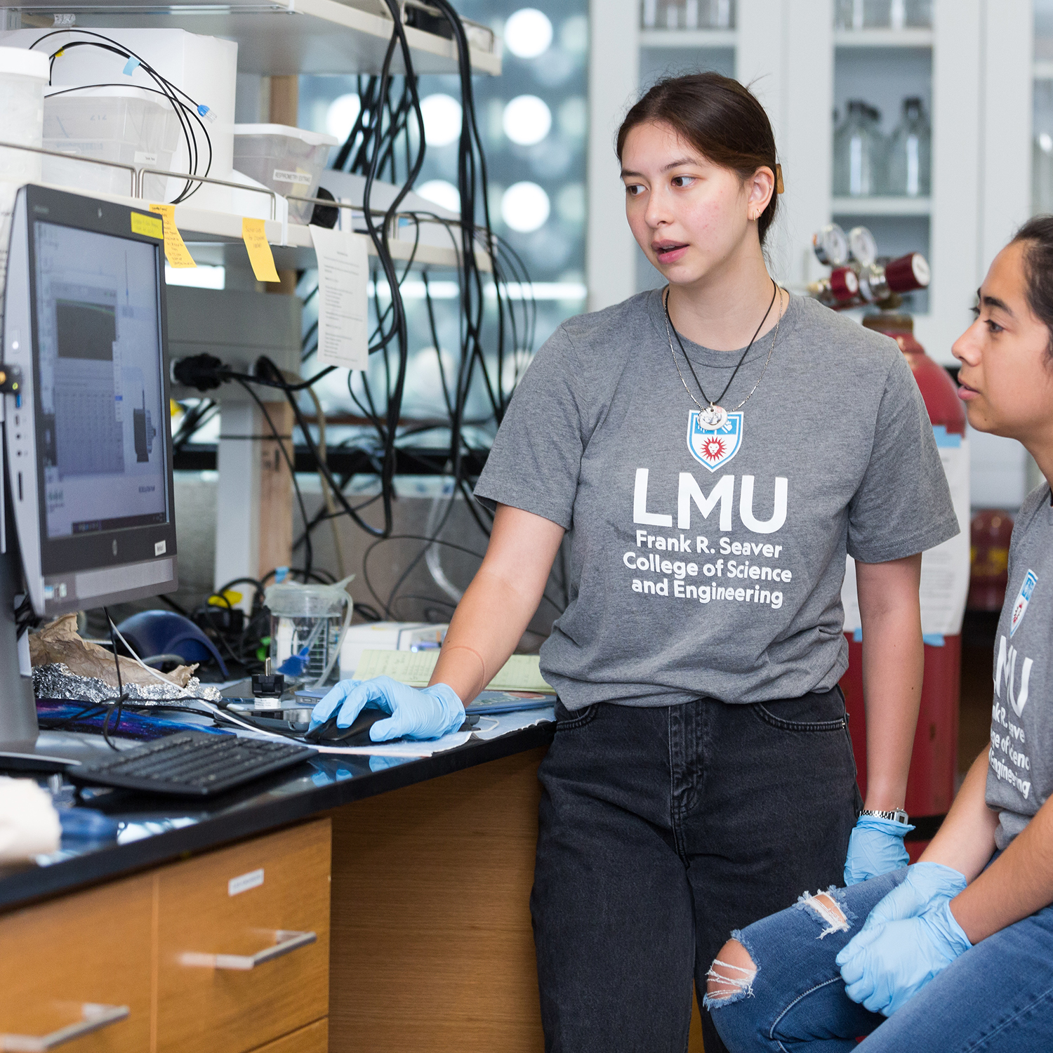 two women looking at a computer screen in a Seaver Lab